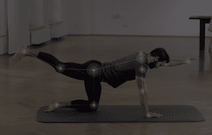 Image shows a man doing excercise on the floor with pose estimation landmarks overlay on his joints. 