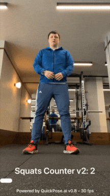 Image shows a fitness app user using the QuickPose AI Squats Counter to count squat reps in the gym. He is an AI engineer wearing a blue exercise tracksuit and orange trainers (sneakers)