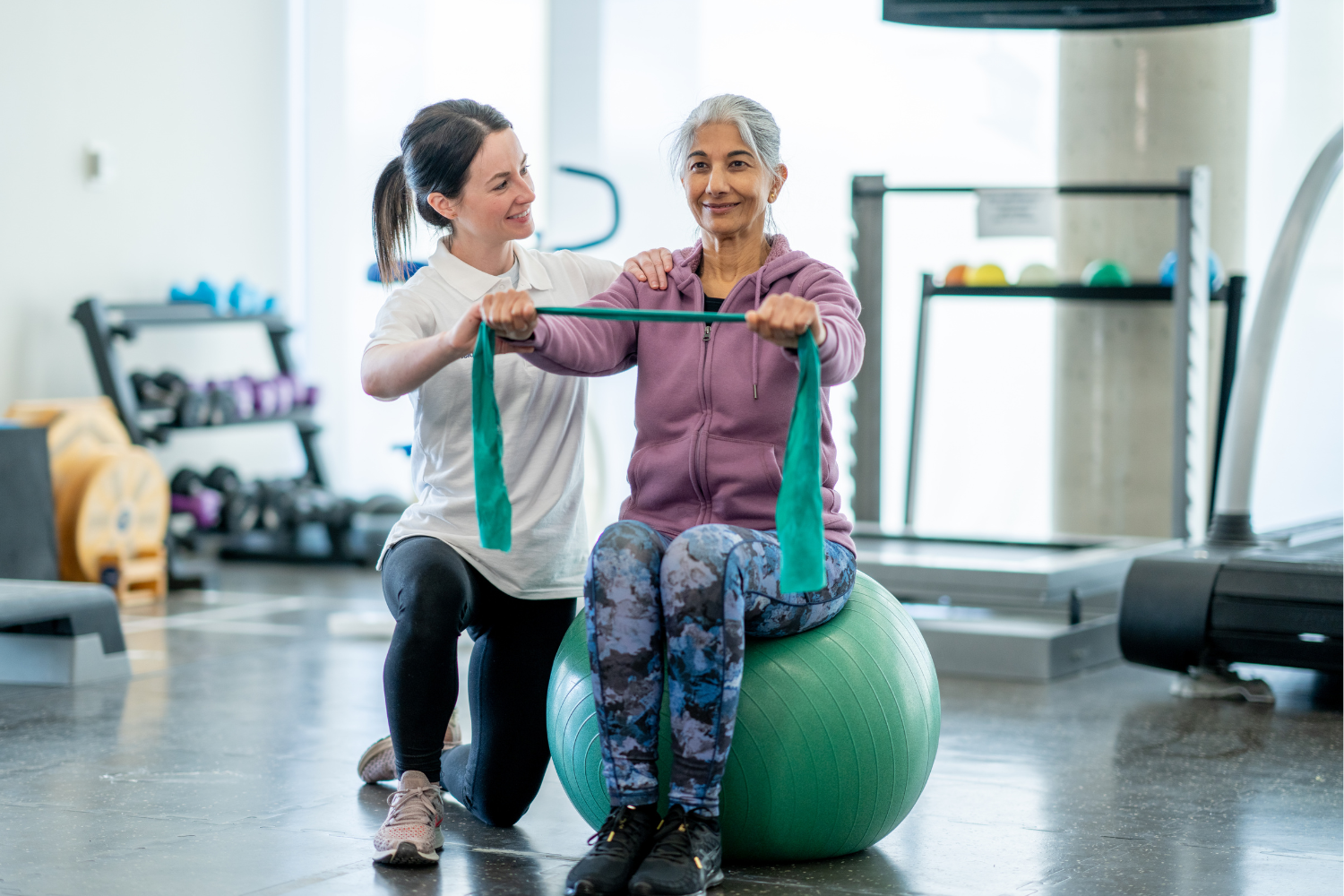 Image shows a physiotherapy patient smiling while receiving treatment.